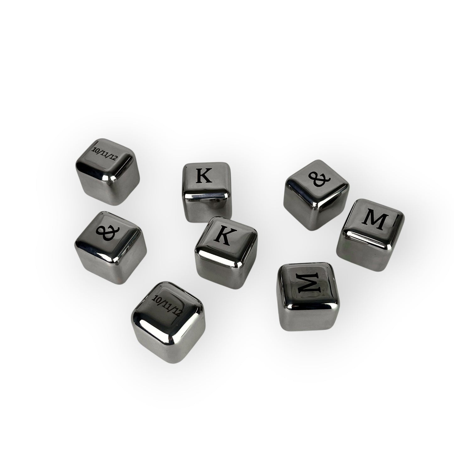 HouseEco engraved stainless steel whiskey stones with letters K, M, ampersand, and date 10/11/12. Set of 8 reusable ice cubes.