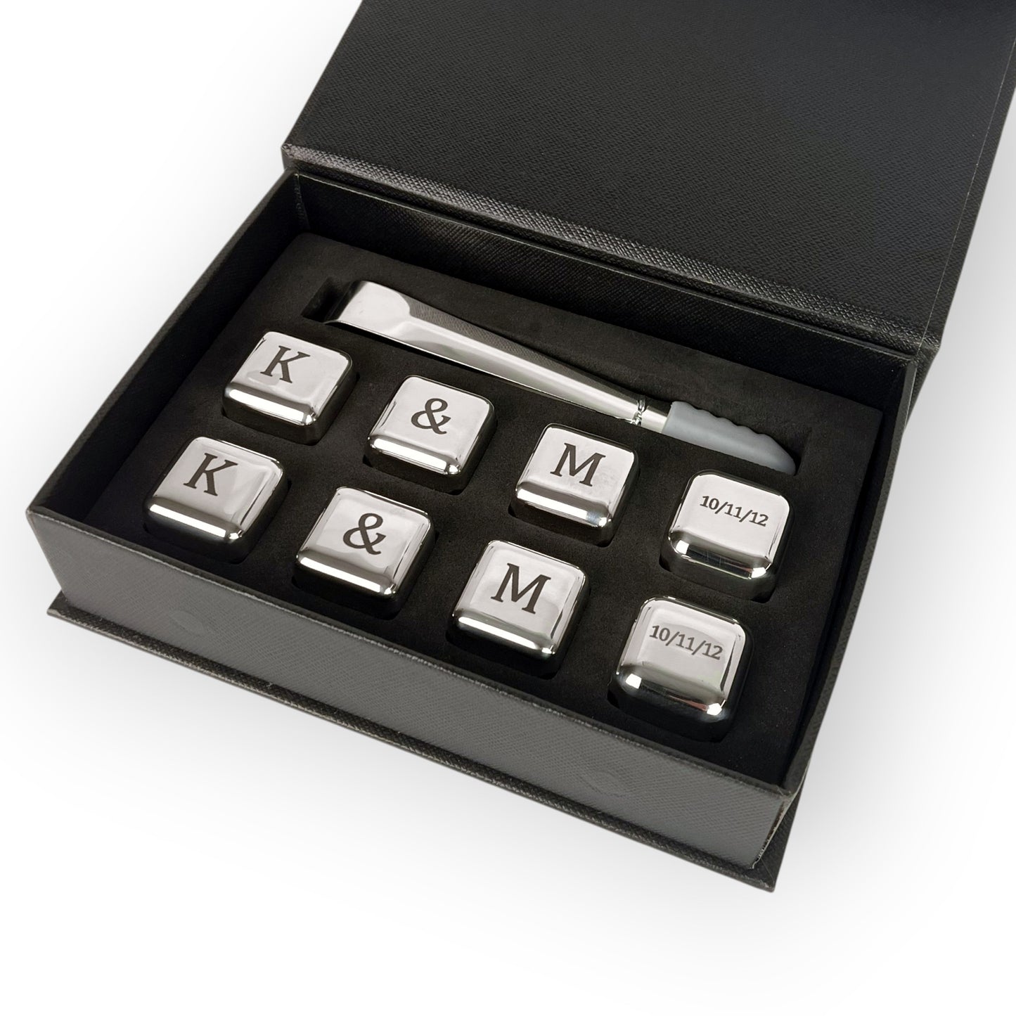 HouseEco engraved stainless steel whiskey stones gift set with tongs and storage box. Features initials K, M, ampersand, and date.