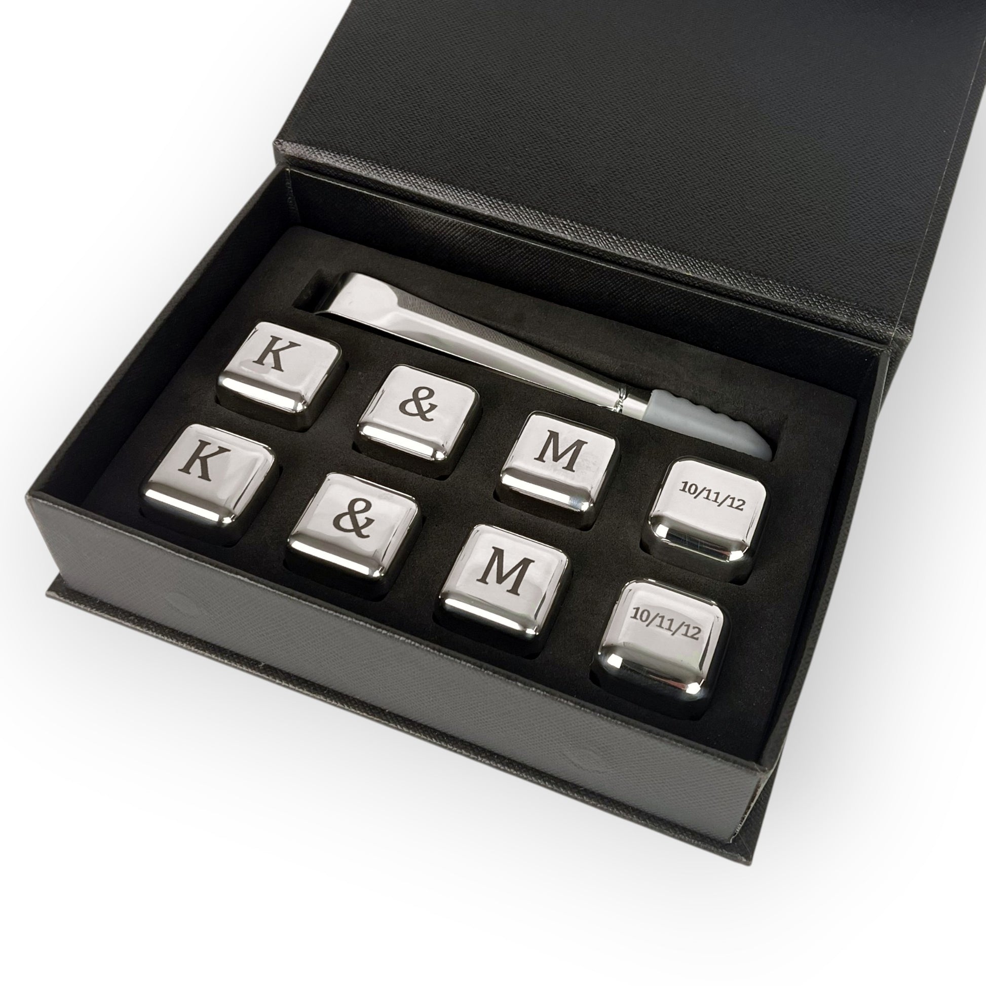 HouseEco engraved stainless steel whiskey stones gift set with tongs and storage box. Features initials K, M, ampersand, and date.