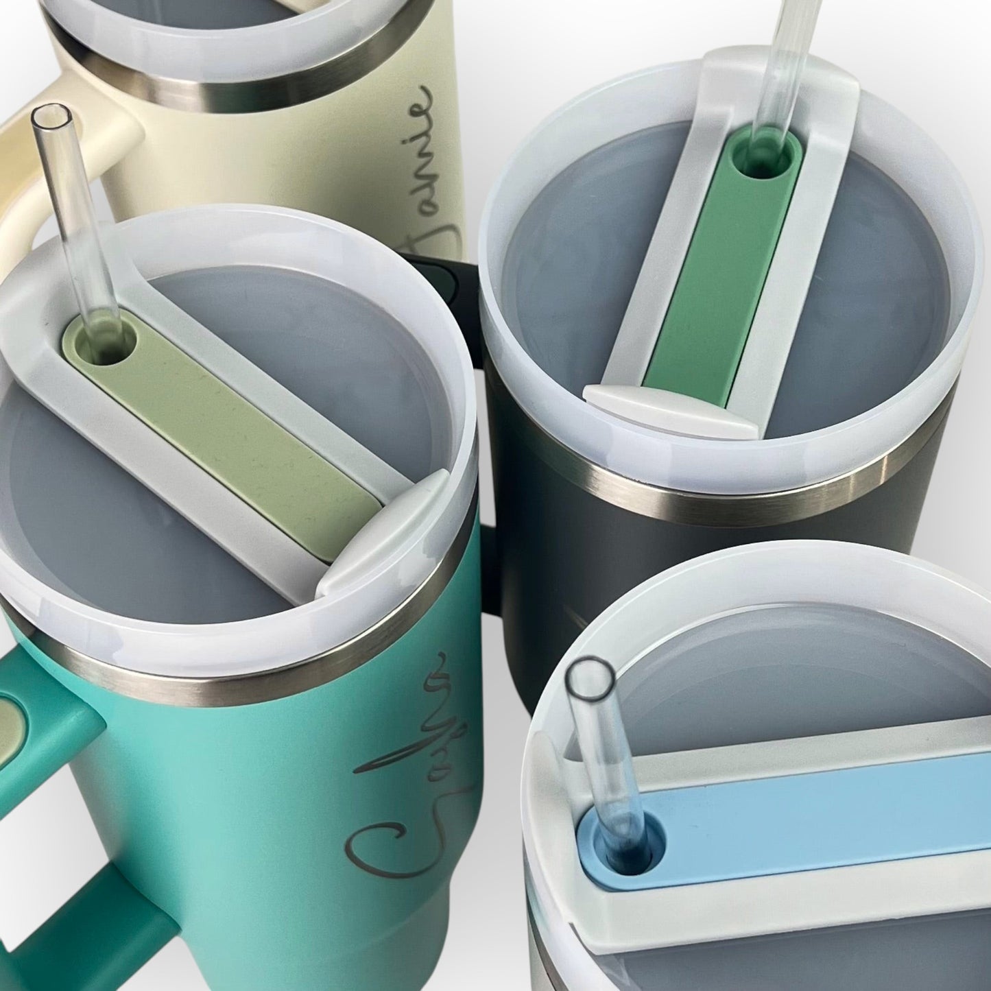 HouseEco personalised large 1.2L stainless steel travel mug with handle, straw, and lid in teal, cream, and grey.