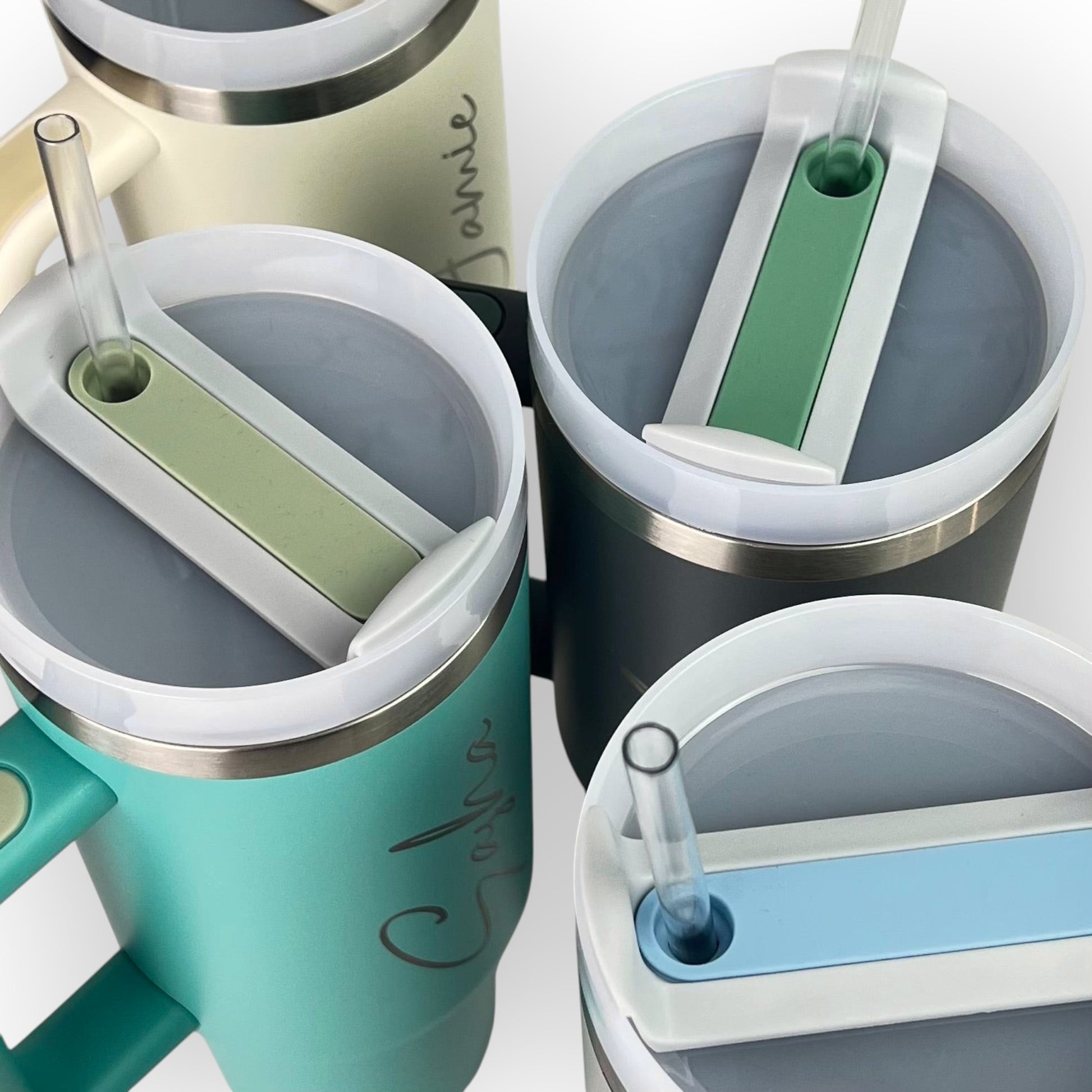 HouseEco personalised large 1.2L stainless steel travel mug with handle, straw, and lid in teal, cream, and grey.